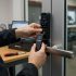 Technician installing a smart lock on a commercial door, showcasing expertise and precision